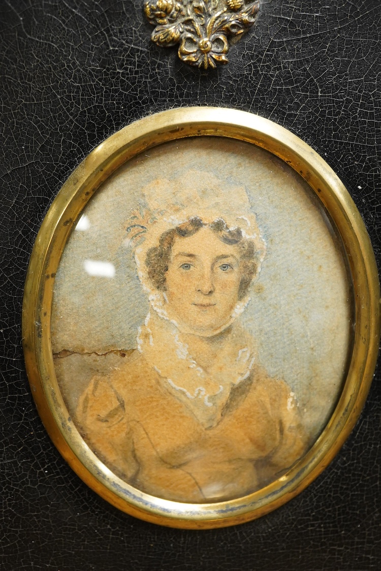 Two 19th century silhouette portraits to include one painted on glass by R. N. Barnes 1836 together with a portrait miniature of a Regency lady and an enamel example, largest 8 x 6.5cm (4)